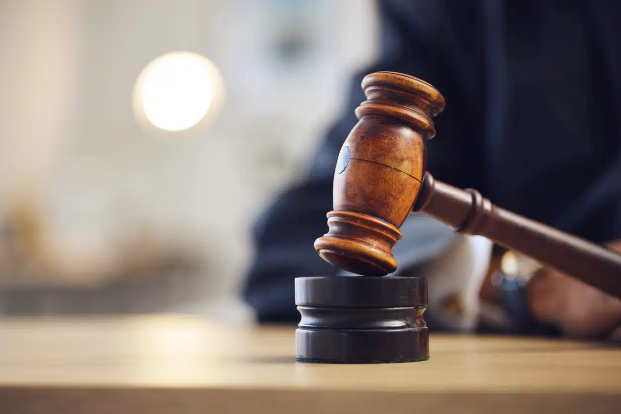 A wooden gavel hits a sounding block, representing the conviction of a misdemeanor or felony in an Alabama courtroom.
